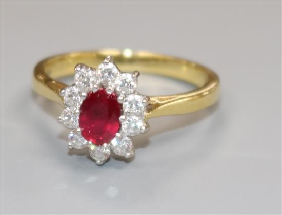 A modern 18ct gold, ruby and diamond cluster ring, size L.
